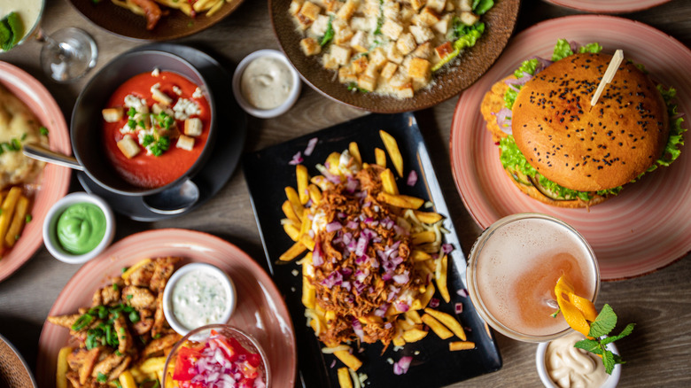 Overhead view of a restaurant table full of food and drinks