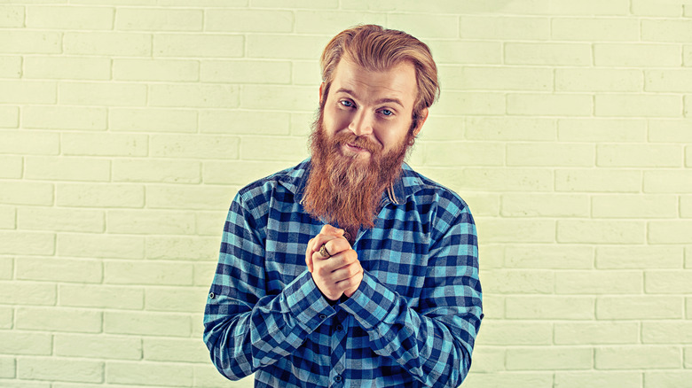 Bearded man making a grateful expression that implies he's saying please