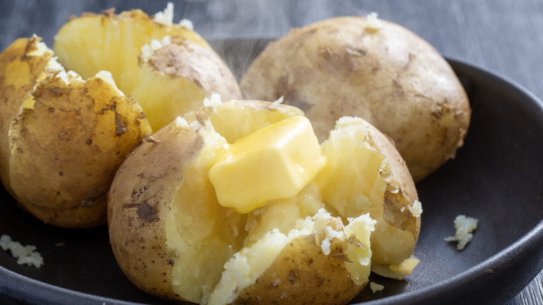 Baked potatoes with a melting pat of butter