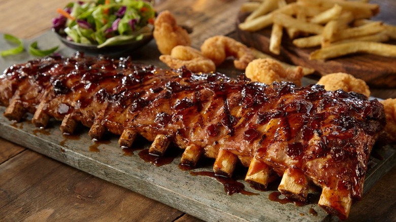 Ribs on board with salad and french fries