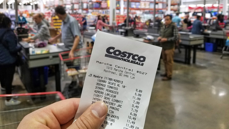Person holding Costco receipt