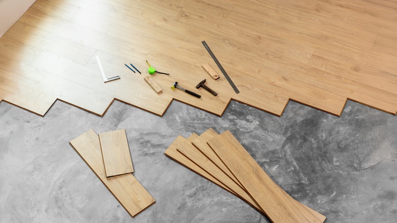Pieces of laminate flooring and tools