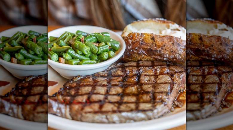 Ribeye steak on a plate with green beans and a baked potato
