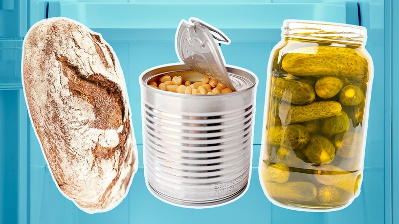 a loaf of bread, an open can of corn, an an open jar of pickles in front of a bluish refrigerator
