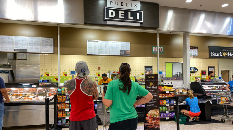 Two people waiting at the Publix Deli counter.