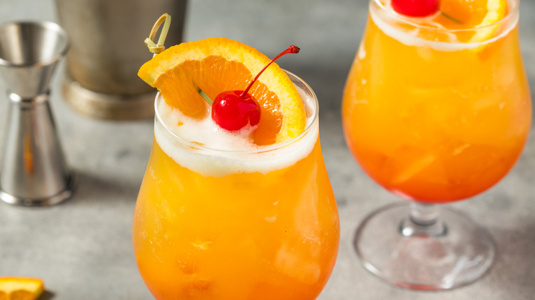 Tequila Sunrise cocktails with cherry and orange flag garnishes