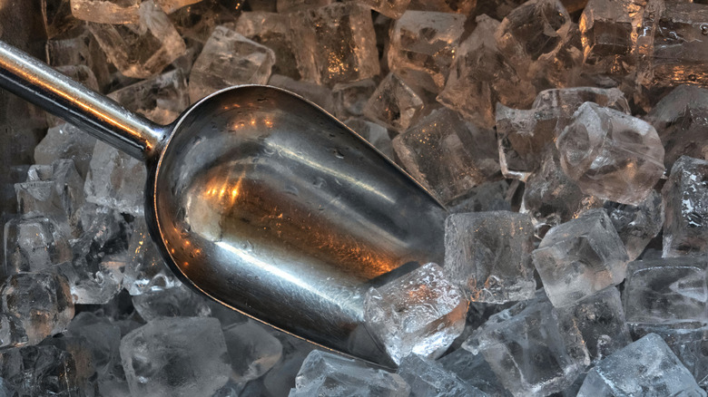 Metal scoop in pile of ice