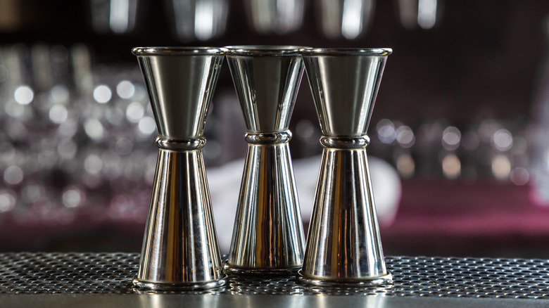 Jigger bartender tools lined up on bar top