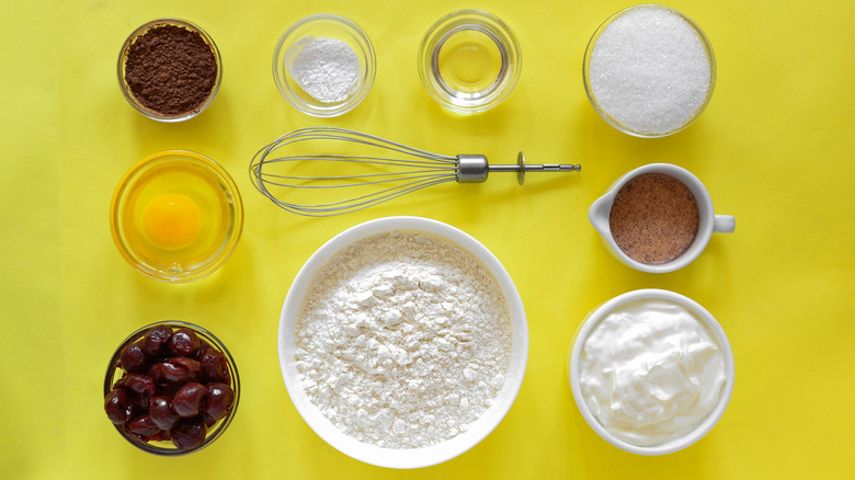 baking ingredients on yellow background overhead view
