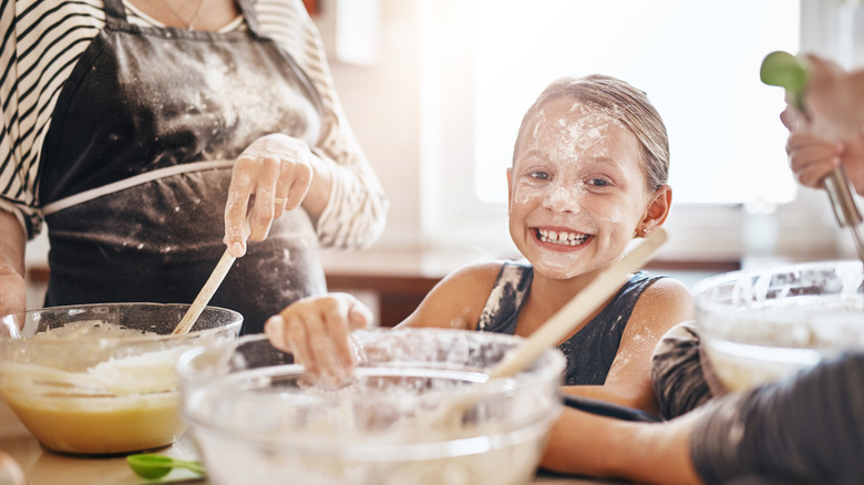 little girl covered in flour