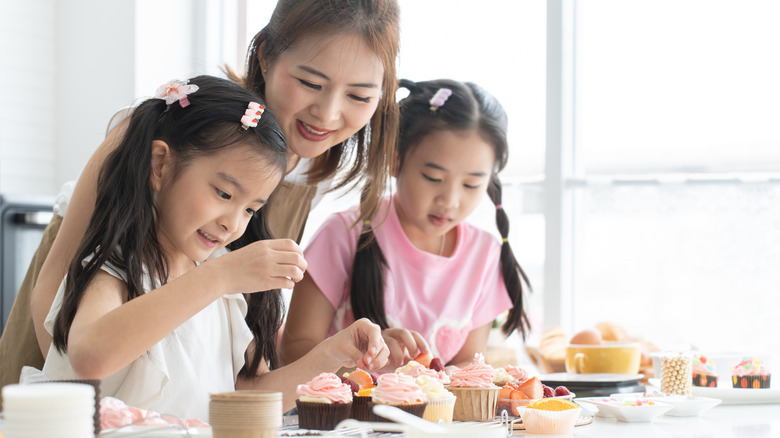 little girl learning to bake with adult