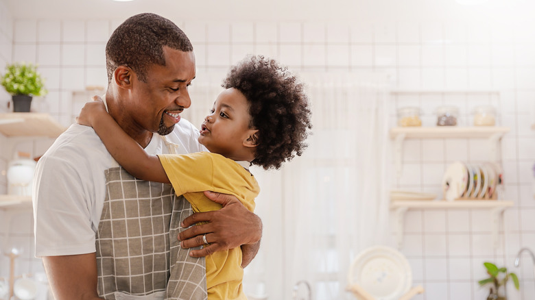little boy with man in kitchen