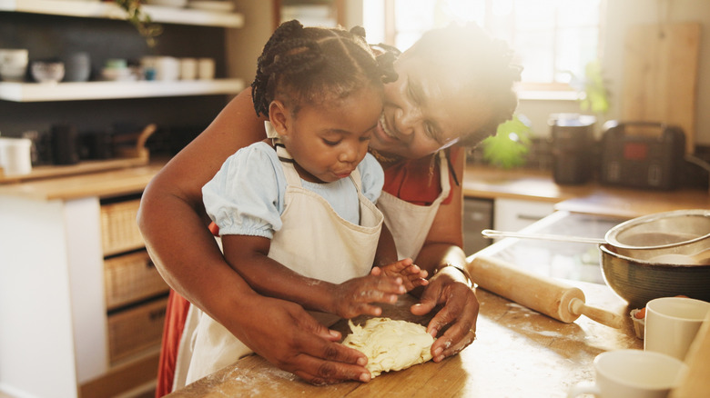 older woman baking with little girl