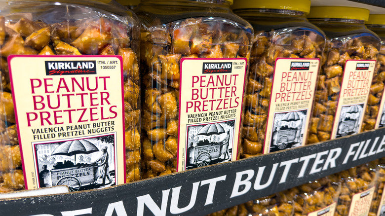 Large tubs of Costco peanut butter pretzels on the store shelf