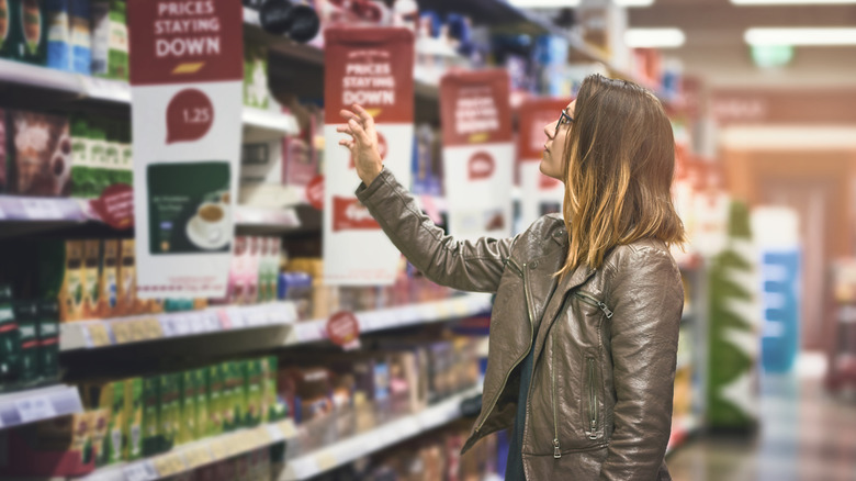 A person cautiously shopping in a grocery store