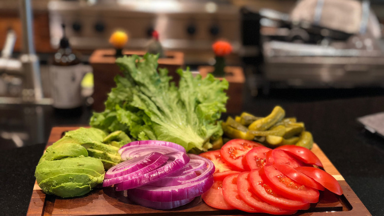 Fresh chopped veggie toppings on board