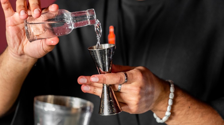 pouring liquid into a jigger