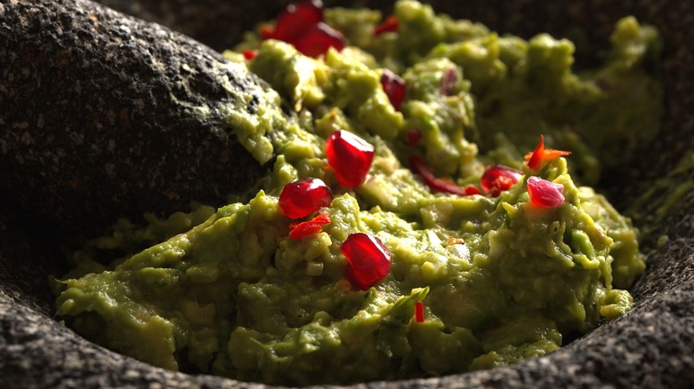 Pomegranate seeds are mixed into guacamole