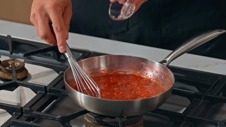 Red wine sauce simmering in a stainless steel pan