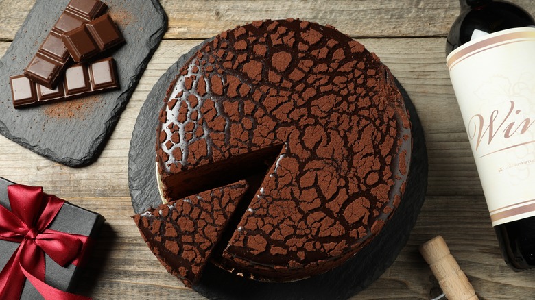 Chocolate cake with bottle of wine