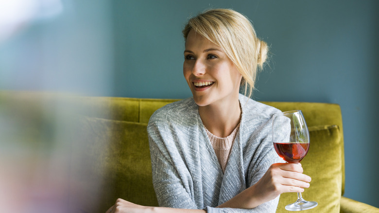 Woman smiling with a glass of red wine