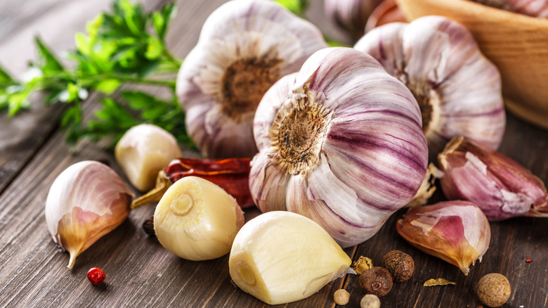 Heads of garlic and cloves on a wooden table