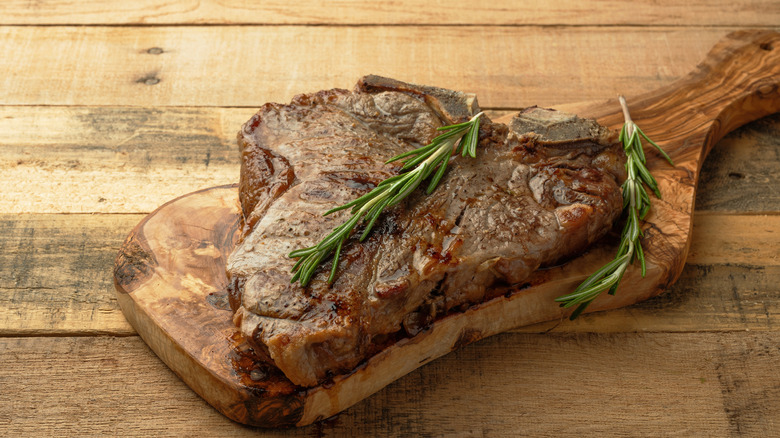 A steak resting on a cutting board
