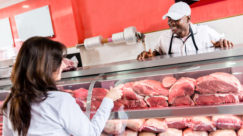 Woman buying fresh meat