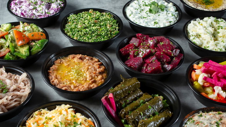Several black bowls containing various side dishes