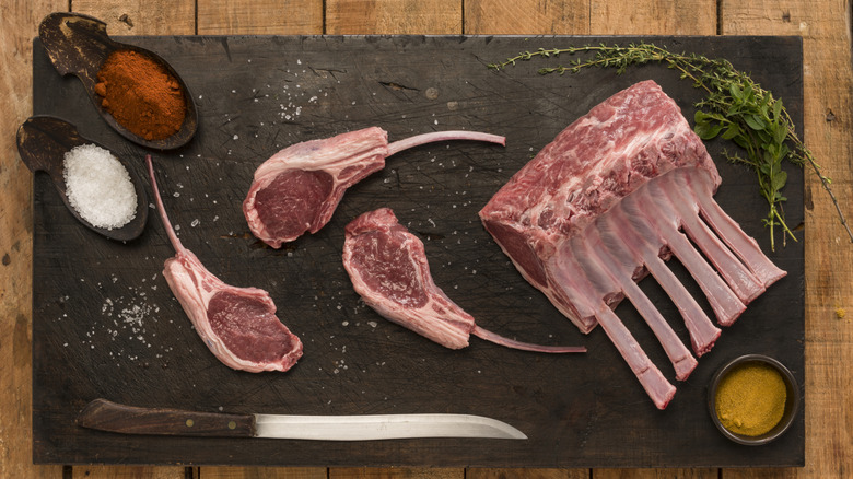 A rack of lamb being cut into chops