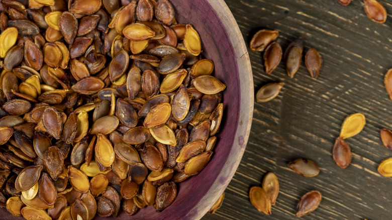 Roasted pumpkin seeds in a rustic bowl