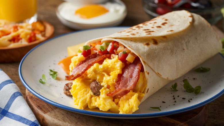 A breakfast burrito on a plate
