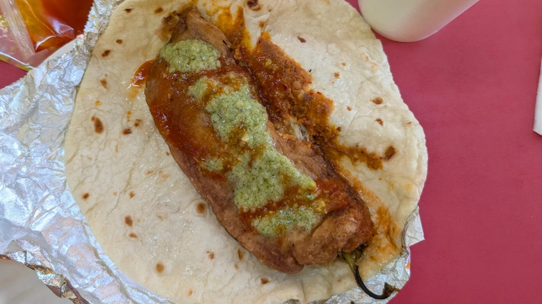 An open burrito de chile relleno on a table