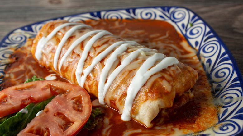 A wet burrito on a plate