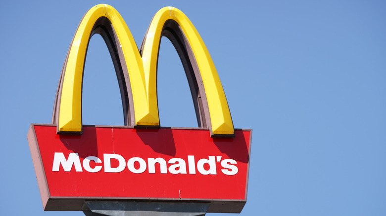 A McDonald's sign is pictured against a blue sky.