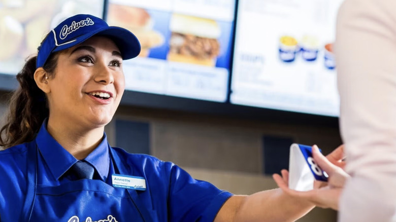 Culver's cashier hands customer table tent.