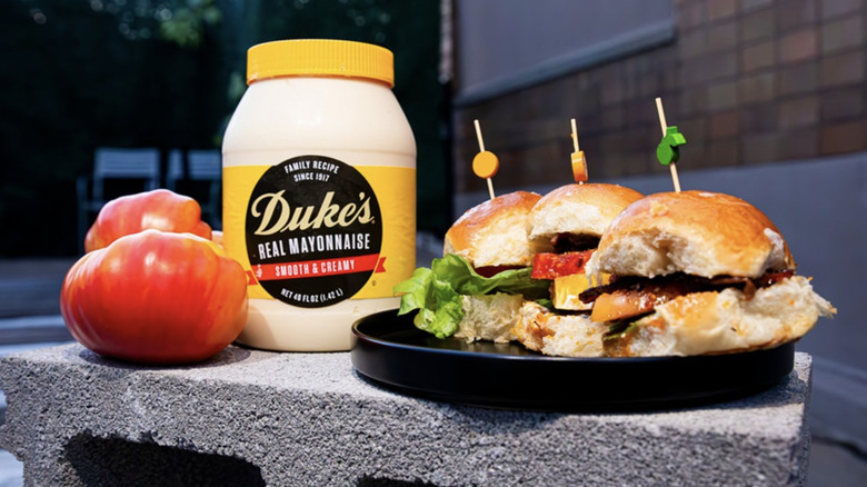 jar of Duke's Mayo next to tomatoes and small sliders