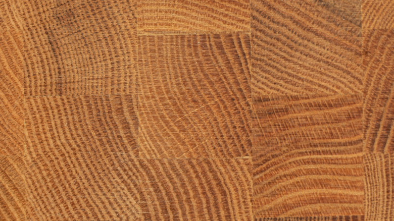 A scratched and nicked butcher block countertop