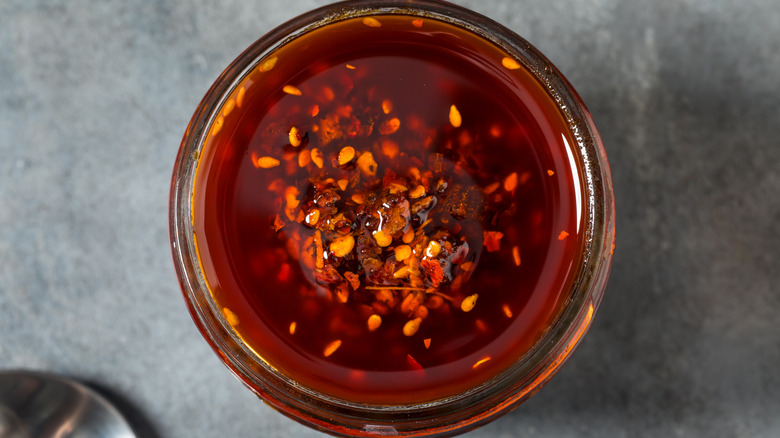 Red spicy chili oil in glass bowl
