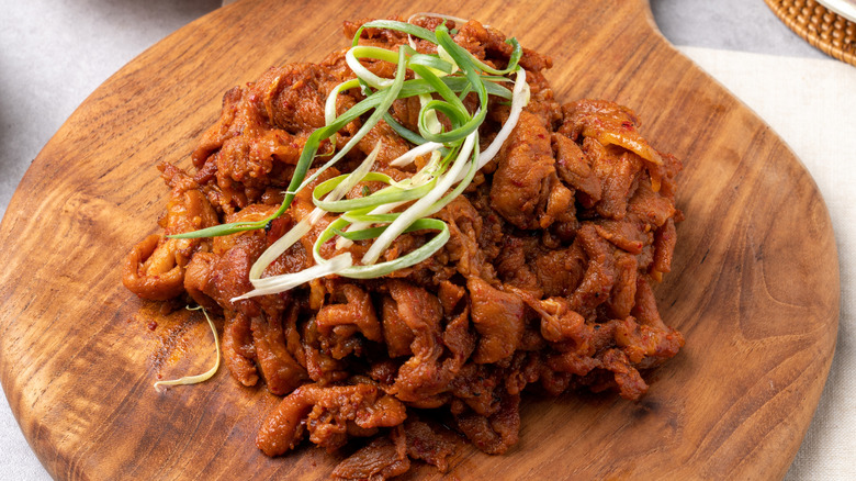 Tender marinated pork belly on wooden cutting board