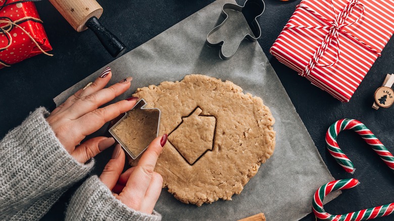 Person making gingerbread house walls