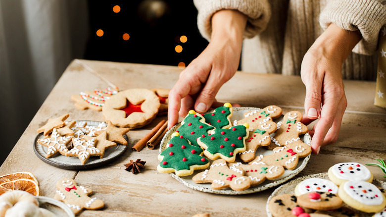 Person holding tray of Christmas cookies