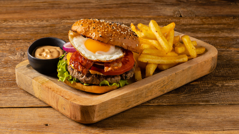 Burger with fried egg and fries