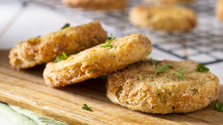 Fried green tomatoes on a wooden board
