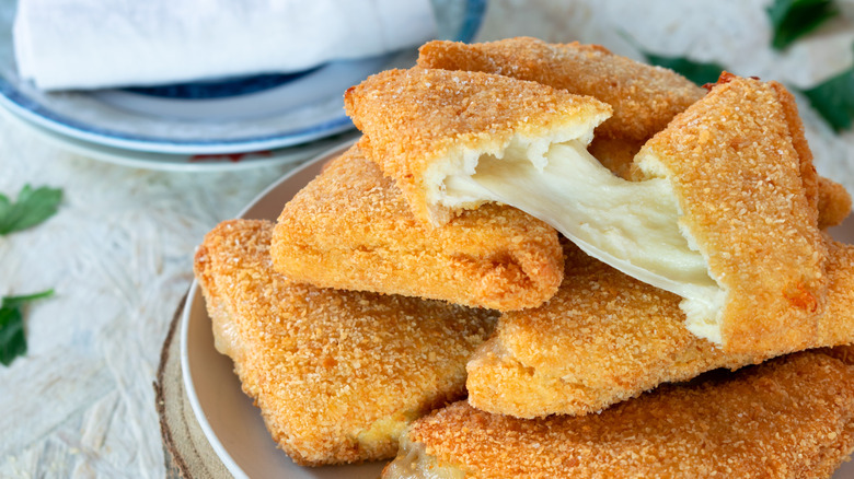 Blocks of fried mozzarella on a plate