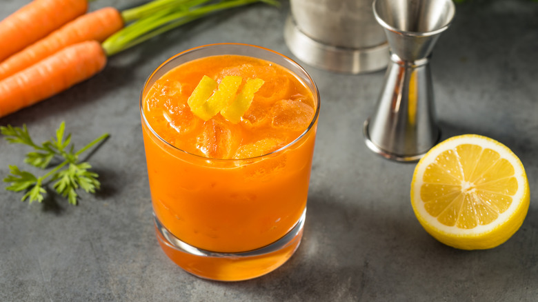 A carrot juice cocktail in a short glass