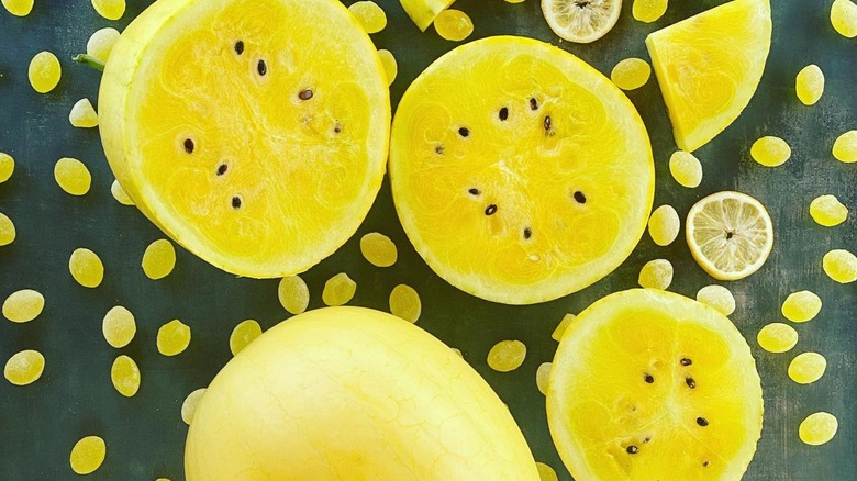 Lemon Drop Watermelons, cut in half and displayed on a background with lemon drop candy
