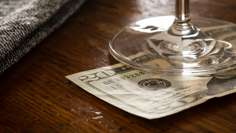 Bill under cocktail glass