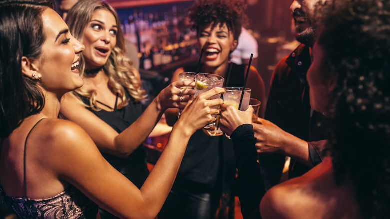 Group of people partying together with drinks