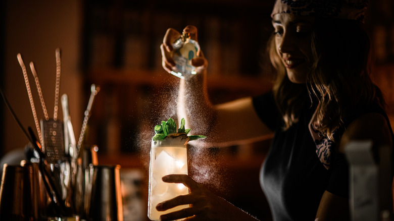 Person crafting cocktails in a speakeasy